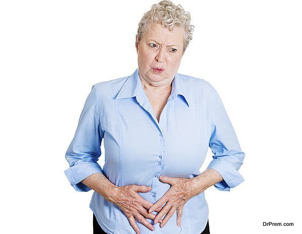 Closeup portrait old business woman, elderly boss, corporate worker, unhealthy grandmother doubling over in stomach pain, isolated white background. Human emotions, facial expressions. Acute abdomen