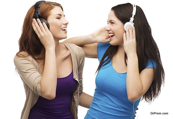 two laughing girls with headphones