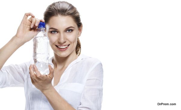 european woman with bottle of clear water
