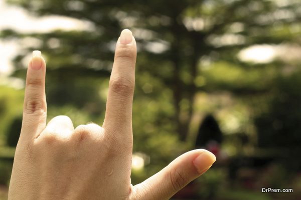 young girl hand in 'I love you' sign