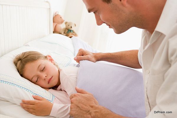 Man waking young girl in bed smiling