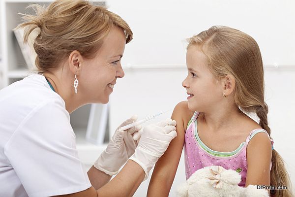 Brave little girl receiving injection or vaccine with a smile