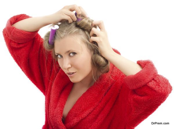 girl removes hair curlers