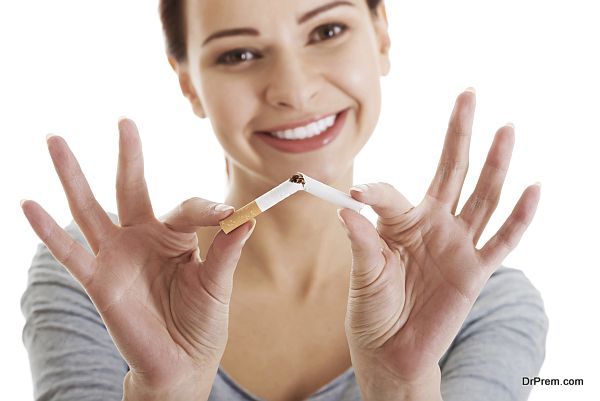 Young beautiful woman holding broken cigarette.