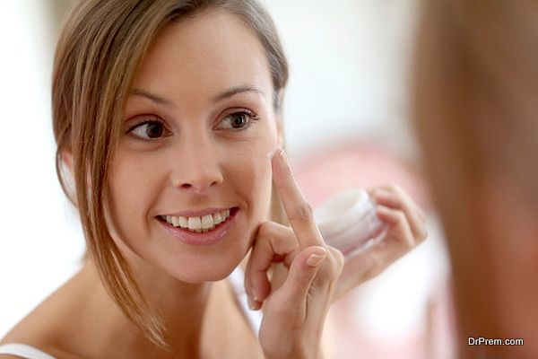 Portrait of woman in bathroom cleaning skin