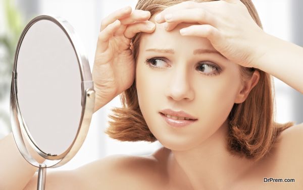 young beautiful healthy woman  frightened saw in the mirror acne and wrinkles