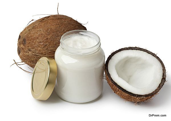 Coconut oil and fresh coconut on white background