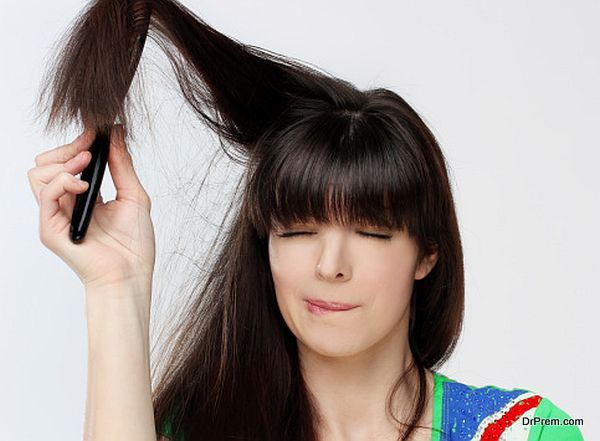 Woman trying to get a brush out of her hair