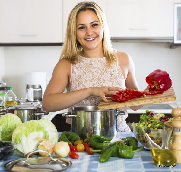 Woman cooking vegetables in kitchen