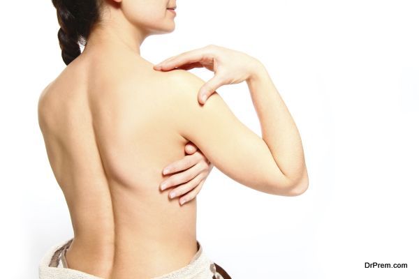 Young woman with a towel isolated on white background