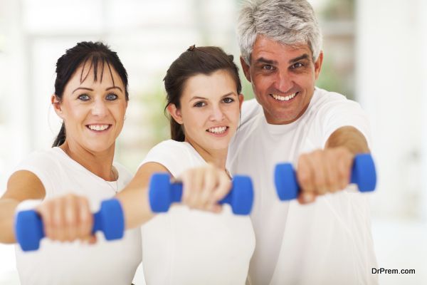 portrait of fit family having fun with dumbbells