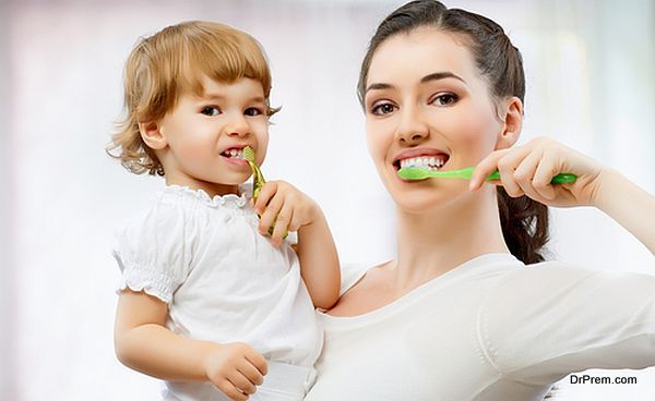 Mother and daughter brushing teeth