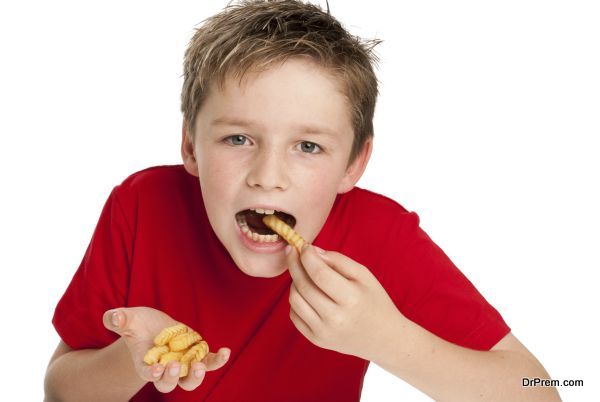 Handsome Young Boy Eating Fries