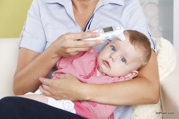 Baby with a digital thermometer