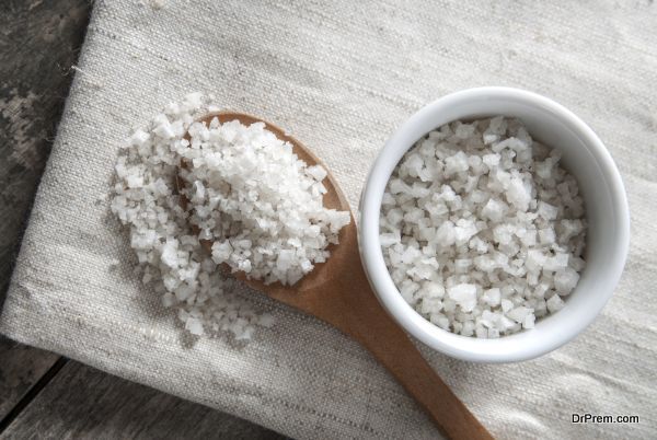 sea salt in wooden spoon on wooden background