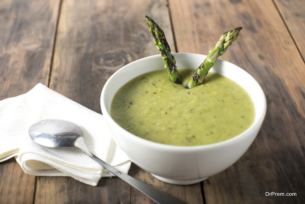 White bowl of cream asparagus soup