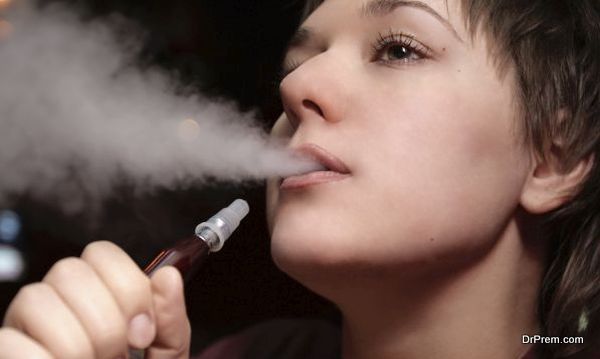 The woman relaxes with hookah in the evening