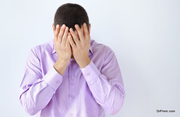 Portrait of business man closed face by two hands