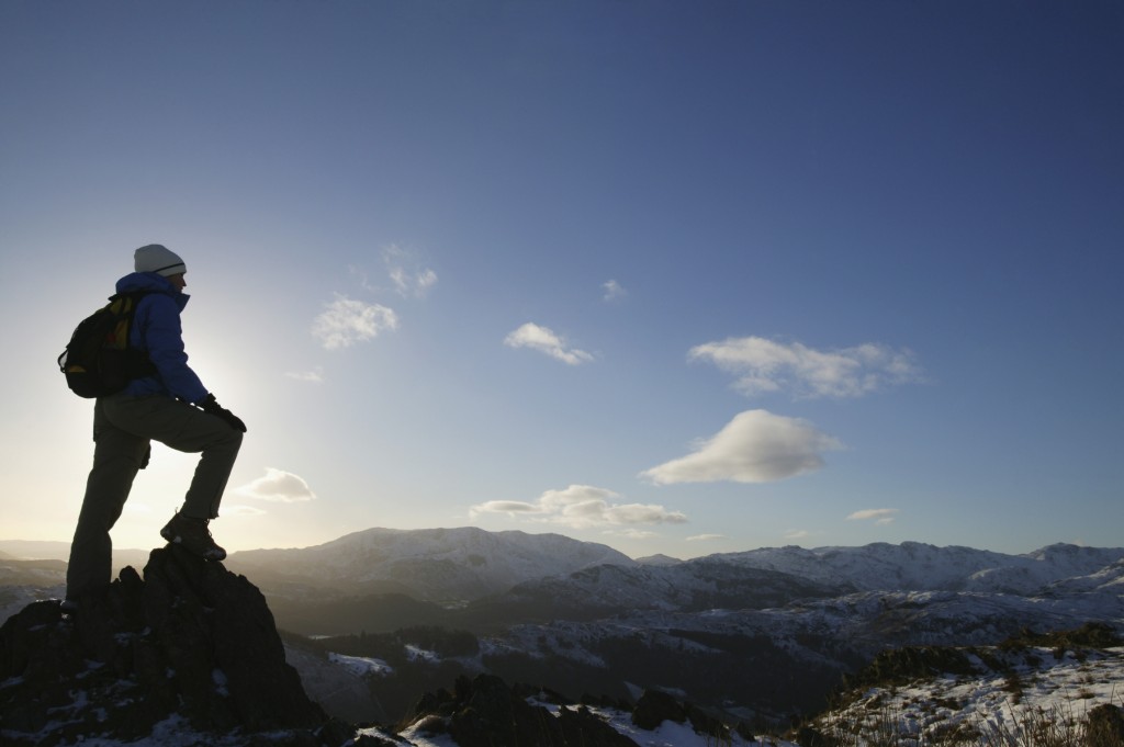 Woman standing on mountain peak