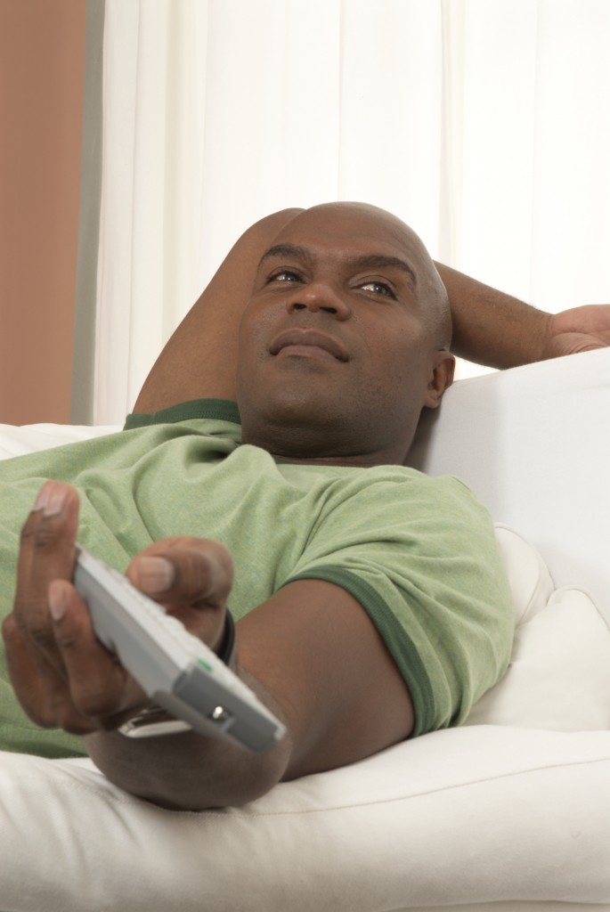 Man using remote control on couch