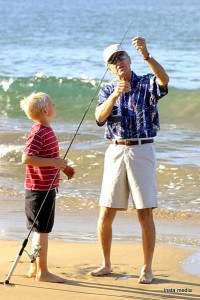 Father teaching his son fishing 