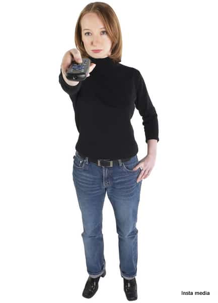 Woman In Jeans Pointing Remote Control