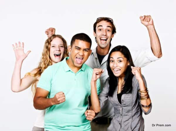 Four young and excited spectators cheer for their team