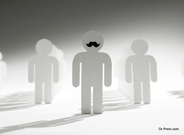 paper cut out of a leader with a mustache