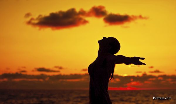 Woman silhouette over sunset