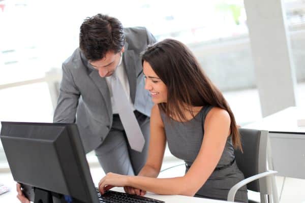 Business people in office working on desktop computer