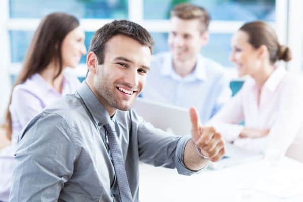 Businessman showing thumbs up