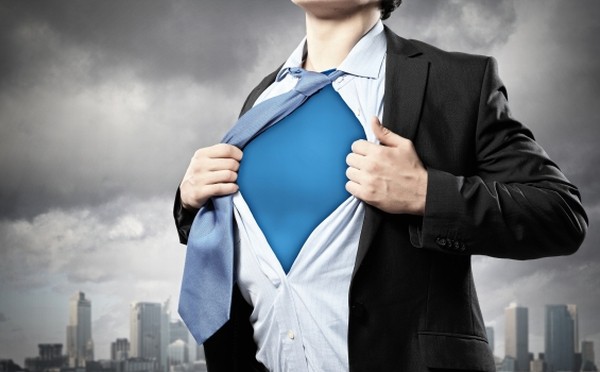 Image of young businessman showing superhero suit underneath his