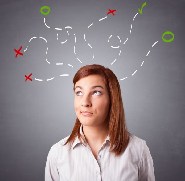 Young woman thinking with abstract marks overhead