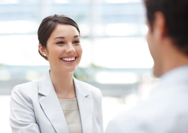 Happy business woman talking with her office colleague