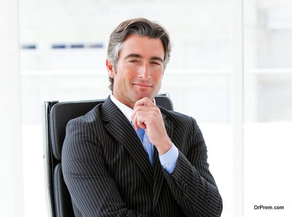 Ambitious male executive sitting in his office in a company