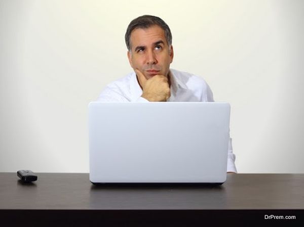 Thinking man with notebook computer