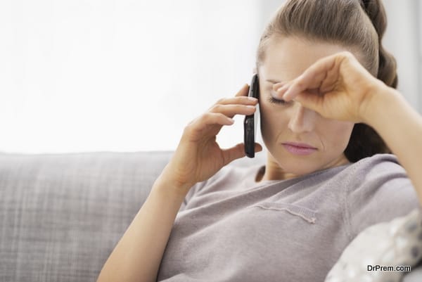 Frustrated young woman talking cell phone