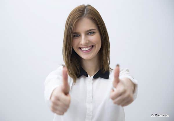 Portrait of a happy woman showing thumbs up