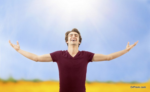 Young man spreading arms in nature