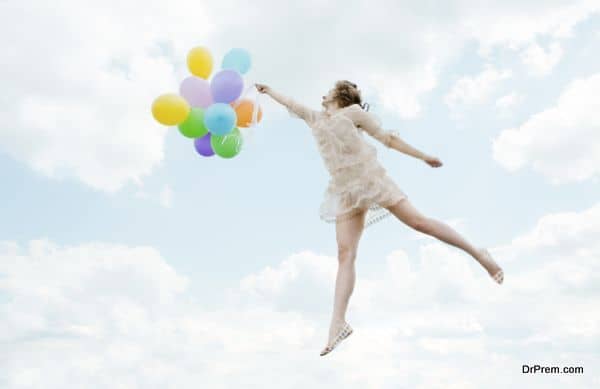 Magic lovely girl flying with Balloons