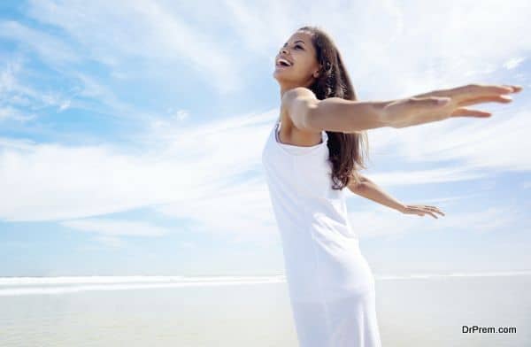 Boat woman smiling happy looking at the sea sailing by. Asian / Caucasian female model.