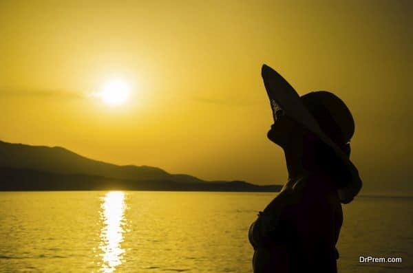 Silhouette girl on the beach during sunset