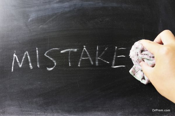 Hand wiping off mistake word using rug