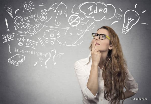 Portrait happy young woman thinking dreaming has many ideas looking up isolated grey wall background. Positive human face expression emotion feeling life perception. Decision making process concept.