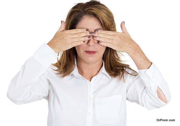 Woman covering eyes