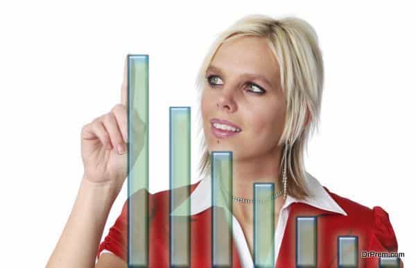 Beautiful businesswoman with bar chart isolated on white