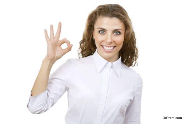 Business woman showing OK hand sign smiling happy.