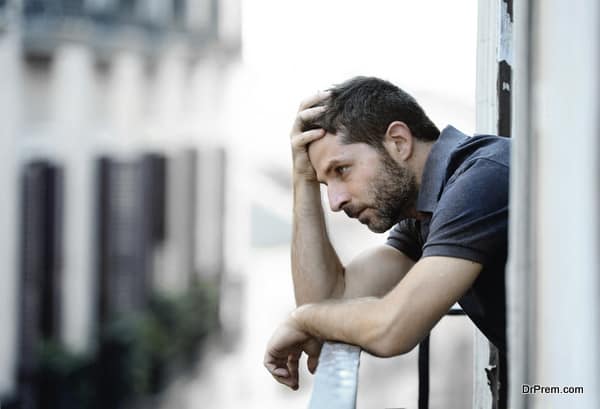 young man at balcony in depression suffering emotional crisis a