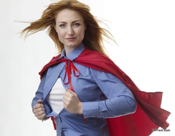 business woman wearing a super hero cape with wind in her hair