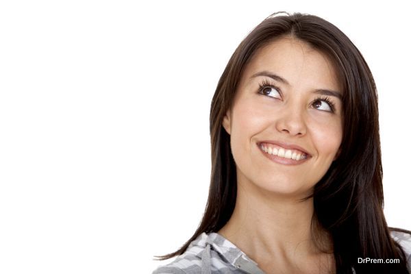 Beautiful thoughtful woman isolated over a white background